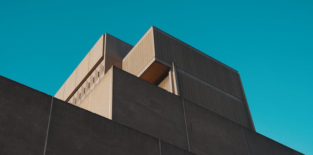 A striking view of a modern concrete structure against a vibrant blue sky in London, Ontario.
