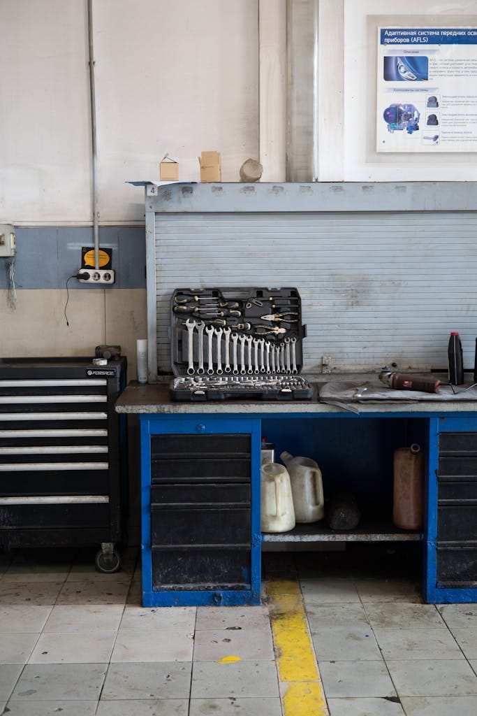 A well-organized workbench in an auto repair shop, featuring a set of tools ready for use.