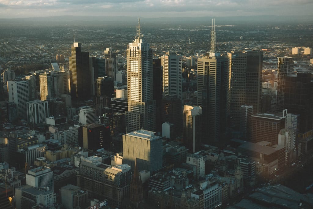 High-angle cityscape of Melbourne's skyline with modern skyscrapers at dusk.